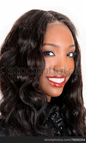 A head shot of a beautiful African American woman with long blackcurly hair, smiling isolated for white background.