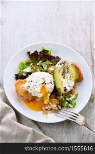 A healthy and balanced breakfast plate.Benedict&rsquo;s egg spreads on a toasted toast with half an avocado, quinoa and lettuce, seasoned spices and yogurt dressing. Enjoy the most important meal of the day
