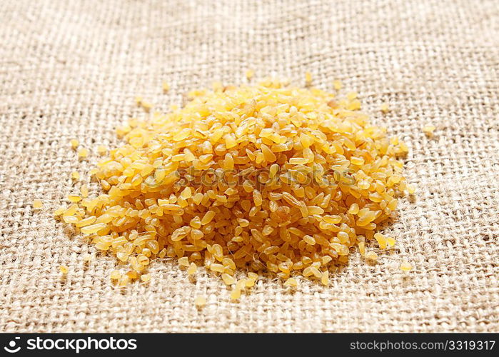 A heap of bulgur on background