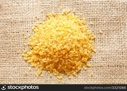 A heap of bulgur on background