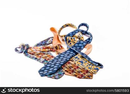 A heap of different ties lying mixed up on a white isolated background.