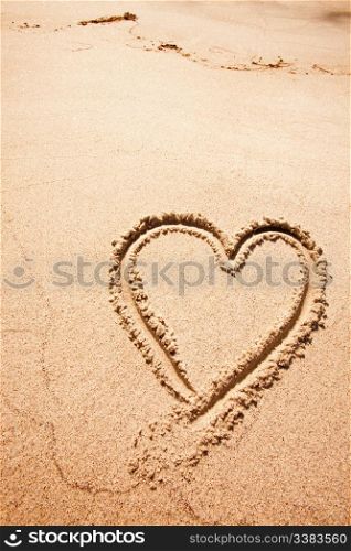 A heart drawn in the sand on a beak