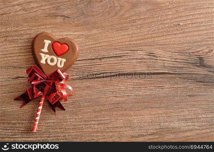 A heart shape chocolate lollipop with the words I love you