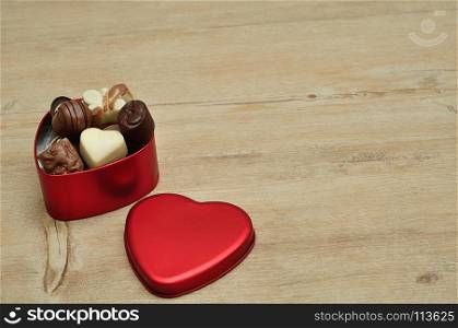 A heart shape tin filled with delicious small chocolates