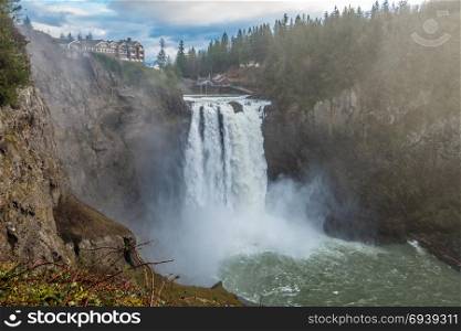 A heavy mist rises as Snoqualmie Falls rushes powerfully.