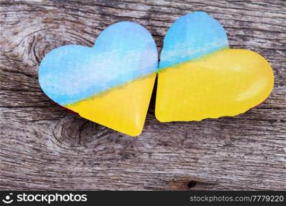 a helping hand helps Ukraine, two hearts n colors of Ukranian flag. a helping hand helps Ukraine