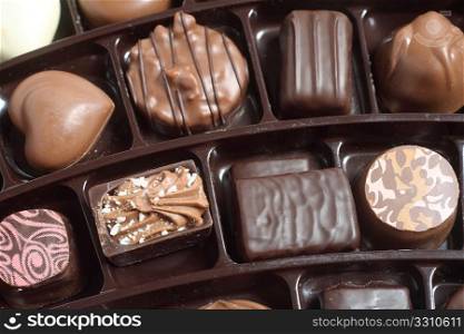 A high-angle view of a tray of luxury chocolates in a box,