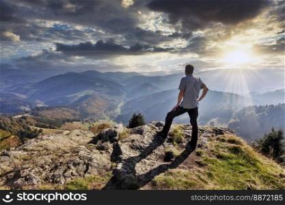 a hiker enjoys the view from Belchen mountain
