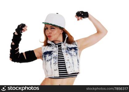 A hip hop woman in a jeans jacket and a hat showing her muscles,isolated on white background.