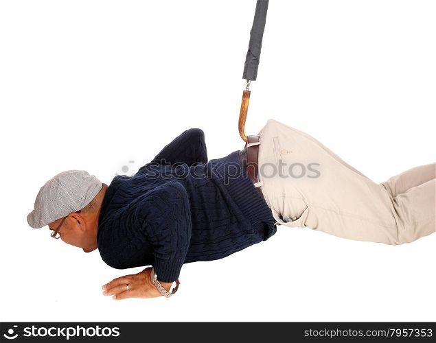A Hispanic man with a had lying on the floor and get&rsquo;s pulled up withan umbrella, isolated for white background.