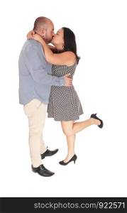 A Hispanic middle age couple standing in the studio and kissing each other, strong love, isolated for white background