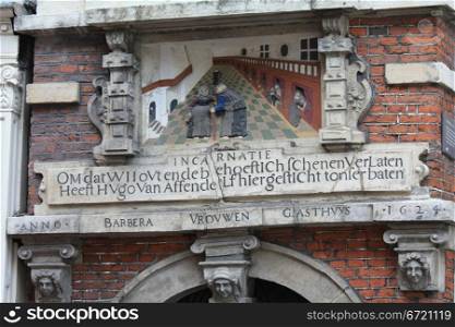 A historic plaque in the gateway of a former hospital in the city of Haarlem, the netherlands