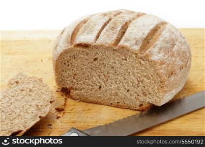 A homemade loaf of Polish rye bread with the end sliced off