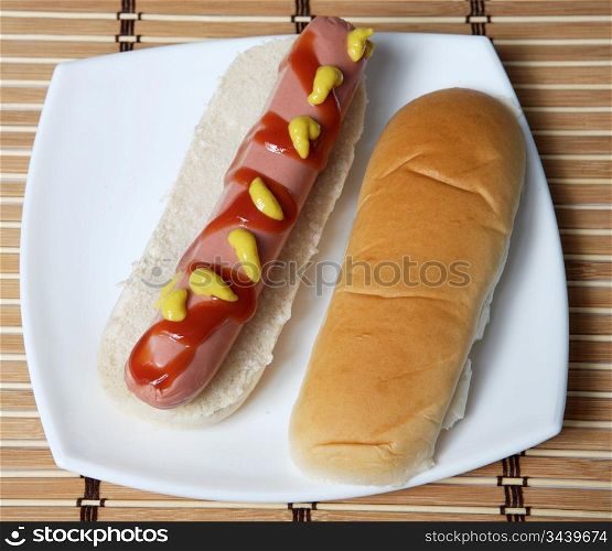 a hot dog in a white plate