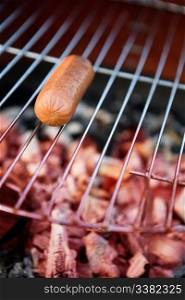 A hotdog on a grill