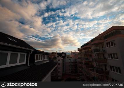 a house against the blue sky with the clouds