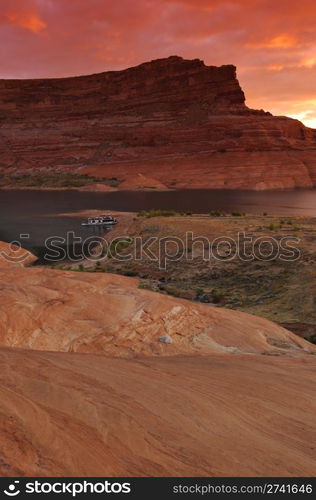 A houseboat is anchored by the shore on a beautiful morning at Lake Powell, Arizona