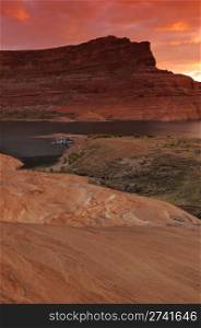 A houseboat is anchored by the shore on a beautiful morning at Lake Powell, Arizona
