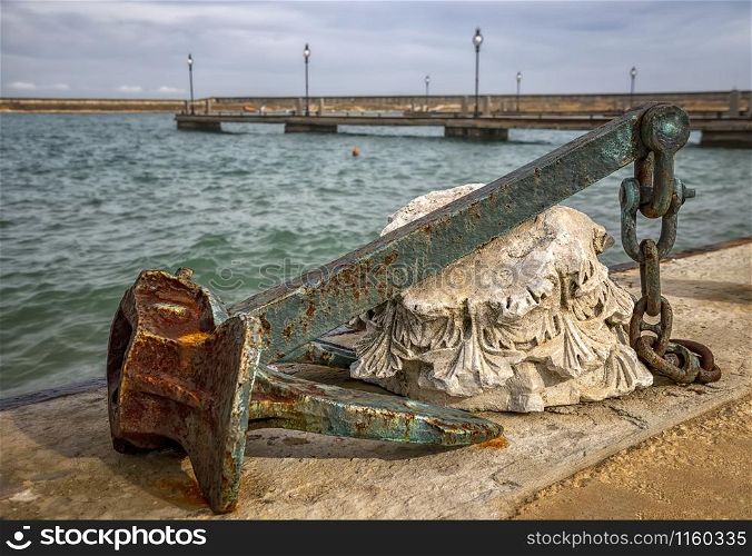 A huge old rusty anchor like a harbor decoration