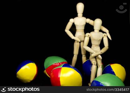 a humanoid couple hugging with juggling balls in bright colors