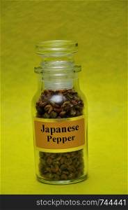 A jar filled with Japanese salt on a yellow background