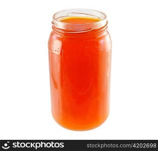 a jar of apricot jelly on white background