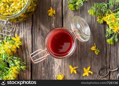 A jar of red oil made from St. John's wort flowers, top view