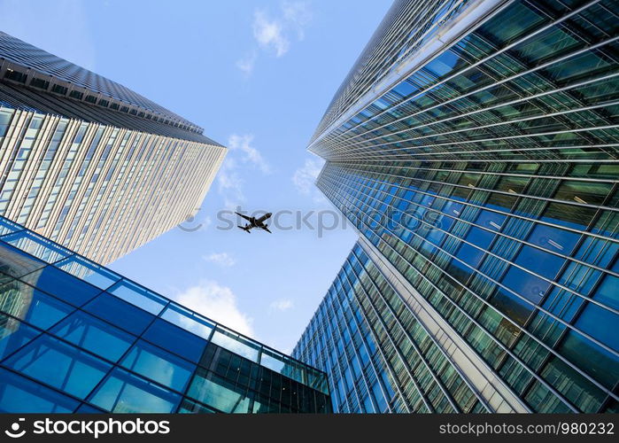 A jet airplane silhouette with business office towers background