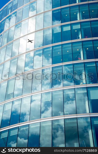 A jet airplane silhouette with business office towers background, London