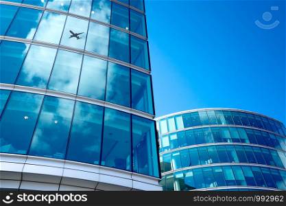 A jet airplane silhouette with business office towers background, London