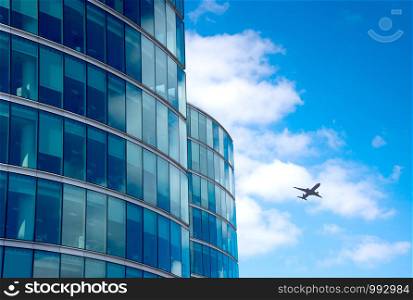 A jet airplane silhouette with business office towers background, London
