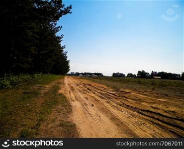 A journey through the Kashubian village. Kashubian region is in north part of Poland. Agriculture and nature concept.. Country road in Kashubian village.