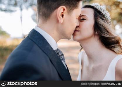 A just married couple kissing on a forest