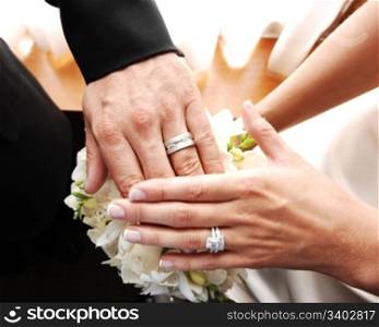 A just married couple shows there nice wedding rings on there finger.