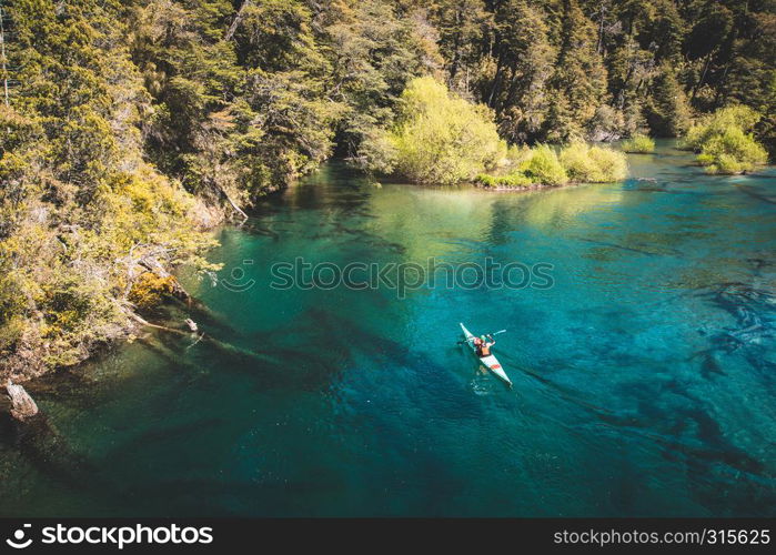 A kayaker on a beautiful lake. Water sport and recreation concept.