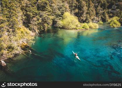 A kayaker on a beautiful lake. Water sport and recreation concept.