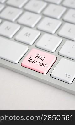 A keyboard with a find love now button