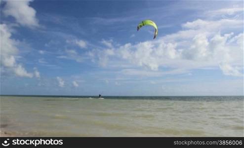 A kite surfer catches a gust and rides it in