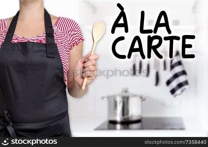 a la carte cook wooden spoon holds background.. a la carte cook wooden spoon holds background