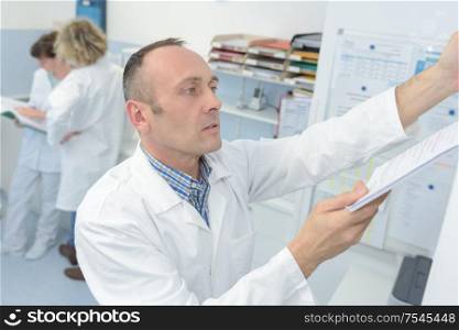 a laboratory worker filing paperwork