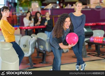 a lady launching bowling ball