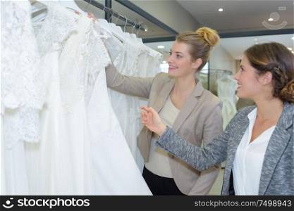 a lady viewing wedding dresses