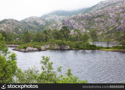 a lake in the middle of big rocky mountains