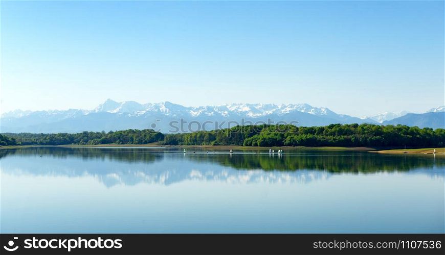 a lake with the mountains Pyrenees in the background
