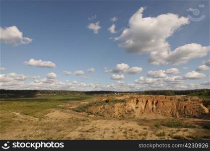 A landscape of plains, rocks and clouds