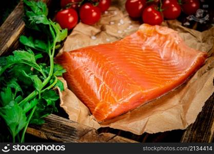 A large piece of salted salmon on a wooden tray. Macro background. High quality photo. A large piece of salted salmon on a wooden tray.