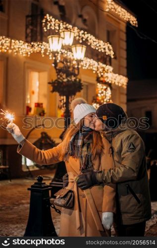 A large portrait of a couple in love on the background of the New Years lights of the city.. Love among the Christmas lights 3079.