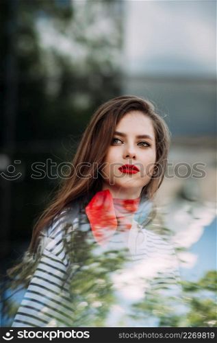 A large portrait of a girl with bright red lipstick.. A beautiful portrait of a woman with bright red lipstick and a scarf around