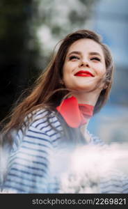 A large portrait of a girl with bright red lipstick.. A beautiful portrait of a woman with bright red lipstick and a scarf around