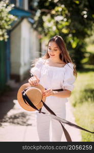 A large portrait of a young girl on a spring walk around the city.. A girl walks around the city in the rays of the spring sun 3616.